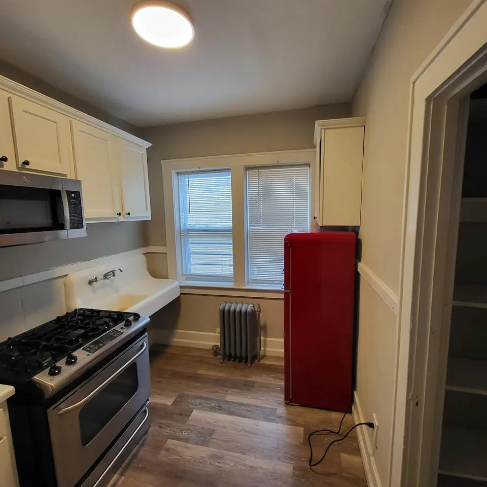 Kitchen with gas range and a red retro refrigerator