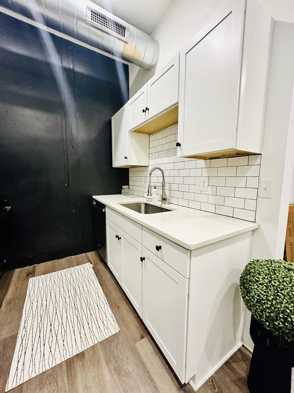 White galley kitchen with stainless appliances