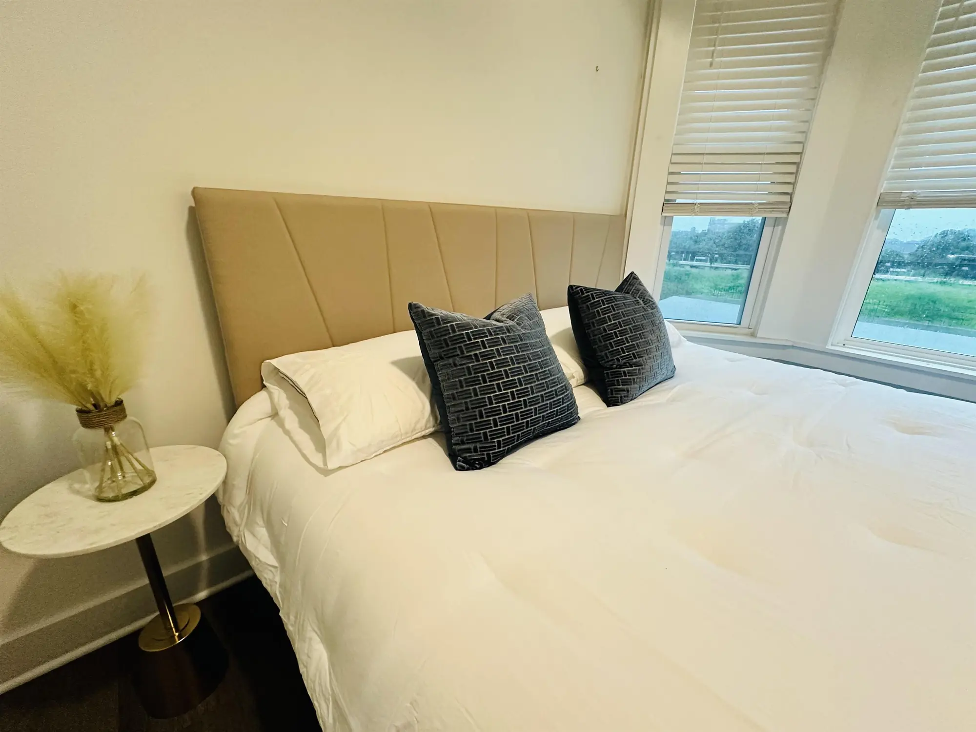 Sunlit bedroom with upholstered headboard