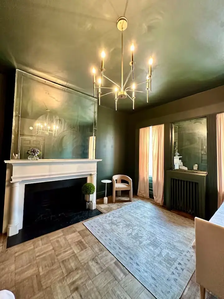 Living room with fireplace and deep green walls