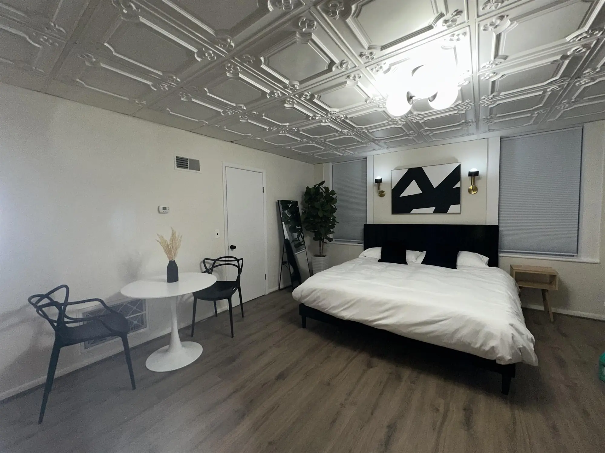 Bedroom under a restored pressed-tin ceiling