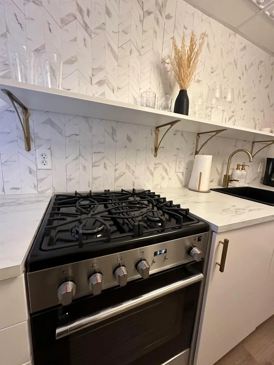 Stainless gas range and open shelving