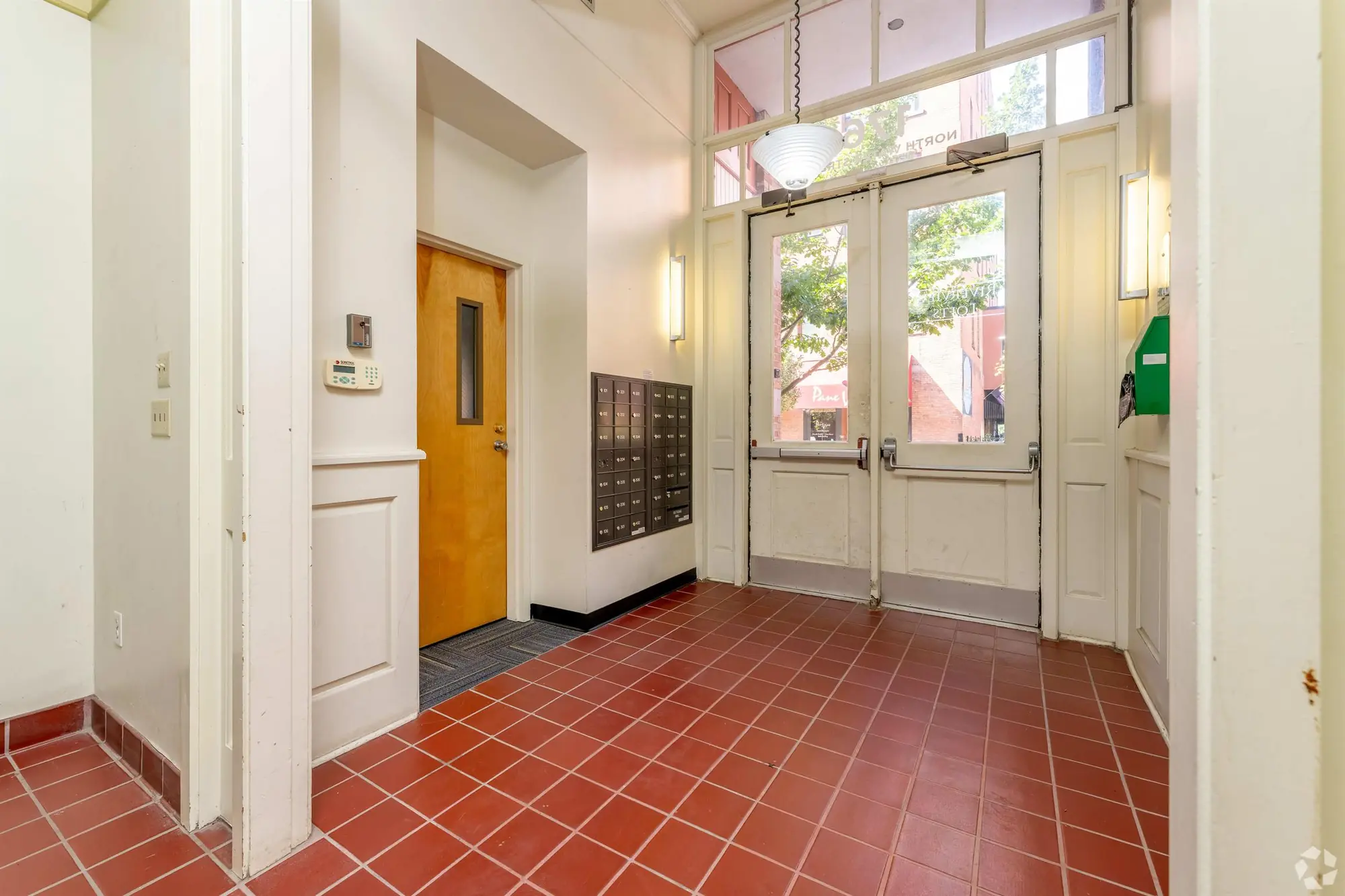 Building entrance with terracotta tile floor